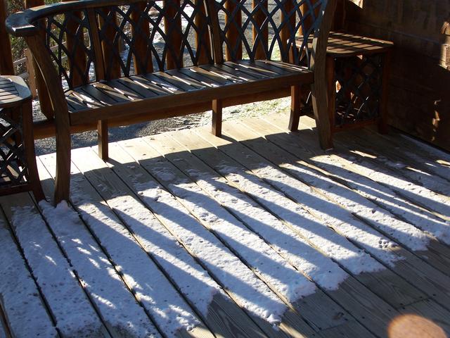 Snow On Back Deck Of Cabin